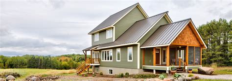 house with green metal roof|farmhouse with green metal roof.